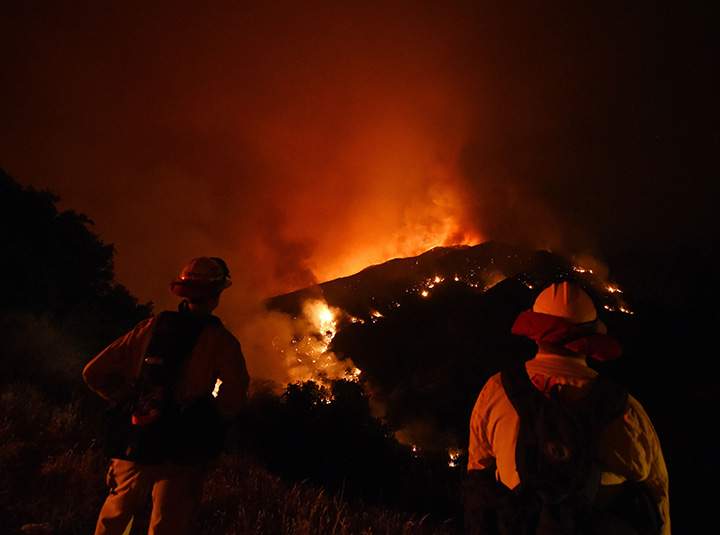 Firefighters watch over the Sand Fire as it moves towards Fair Oaks Canyon in Santa Clarita, California on July 24, 2016.