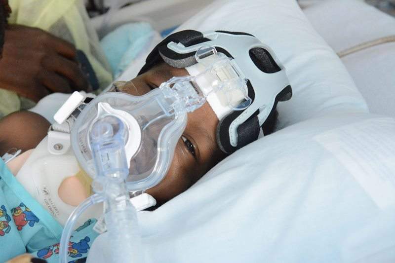 In this June 29, 2016 photo, 3-year-old, Devon Quinn, rests in his hospital bed after being shot while sitting in a car with his father on Father's Day after visiting relatives in Chicago. 