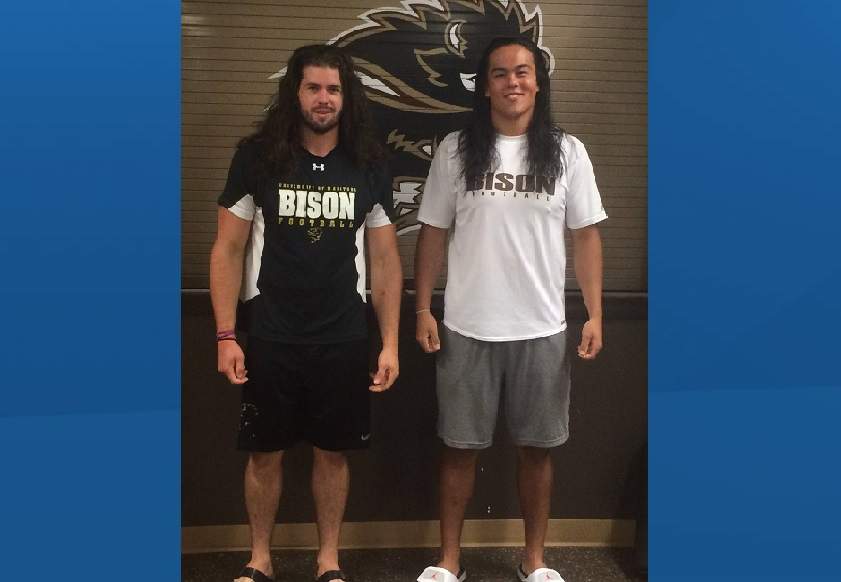 Bison football players Cam Fox (left) and Adam Neiles (right) pose just before cutting their hair for CancerCare Manitoba .