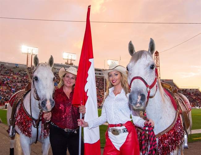 Karyn Drake, left, poses with her daughter Chelsea Drake in this Friday, July 1, 2016 handout photo. There's a new rider in the saddle celebrating home-team touchdowns at Calgary Stampeders' games.