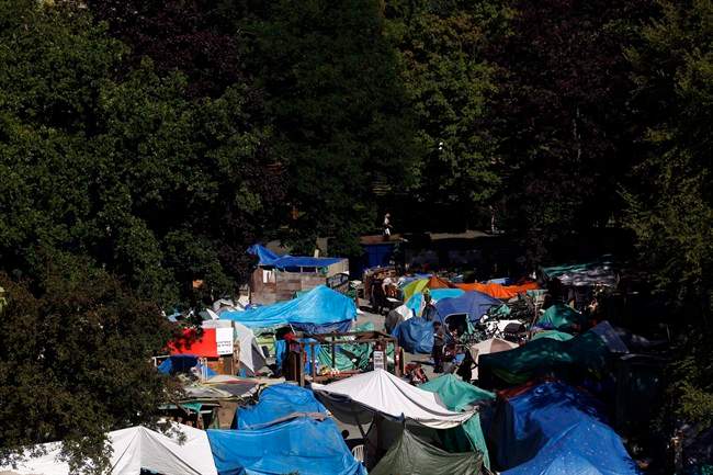 Residents at Tent City, also known as Super InTent City, are seen in Victoria, B.C., Tuesday, June 28, 2016 .