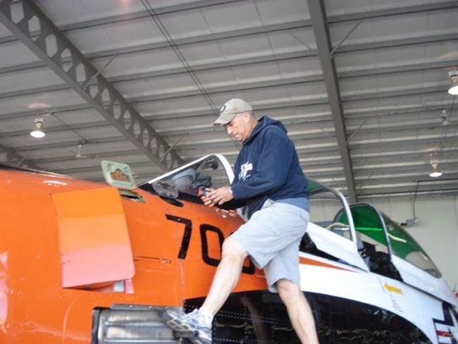 Bruce Evens checks the oil in the engine of his T-28 Trojan in this undated handout photo.