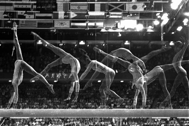 A multiple-exposure photo show Romania's Nadia Comaneci, 14, performing her part of the balance beam routine in the Montreal Summer Olympic Games in a July 23, 1976, file photo. All the world seemed to fall in love with the ponytailed 14-year-old from Romania who became the first to earn a perfect 10 score on the uneven bars.