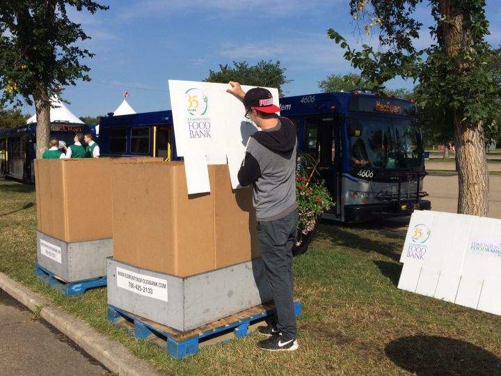 A worker sets up a donation box for the Edmonton Food Bank at the Servus Heritage Festival inside Hawrelak Park.