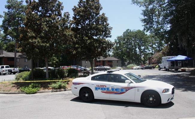 A police vehicle parks near the scene of an officer involved shooting, Friday, July 8, 2016, in Valdosta, Ga. 