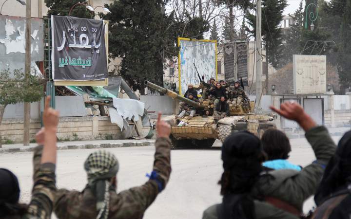 Fighters from a coalition of Islamist forces greet their comrades on March 28, 2015 in the Syrian city of Idlib, the second provincial capital to fall from government control. The capture is a blow to the Syrian regime and raises the prospect that the city will become the effective capital of territory held by Al-Qaeda's Syrian wing, Al-Nusra Front, analysts said.