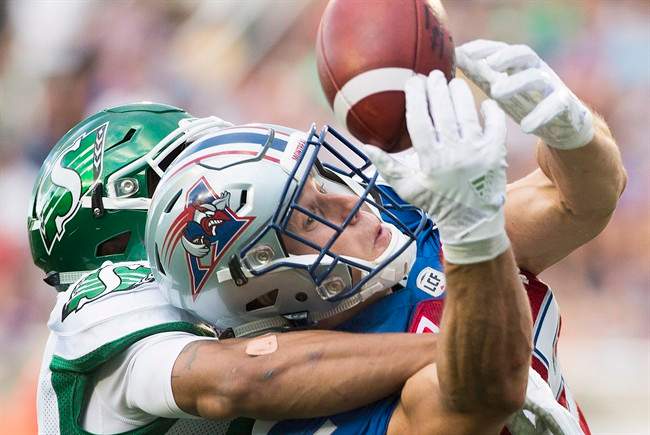 Montreal Alouettes' Samuel Giguere, right, and Saskatchewan Roughriders' Justin Cox go up for the ball during first half CFL football action in Montreal, Friday, July 29, 2016. THE CANADIAN PRESS/Graham Hughes