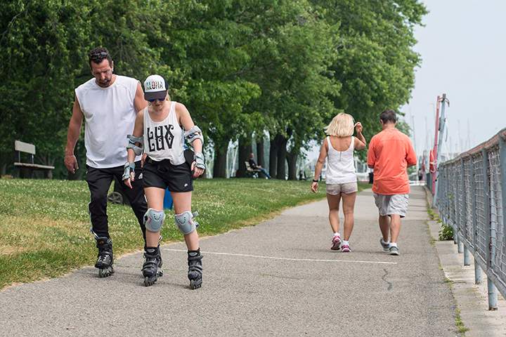 People enjoy the hot weather at Coronation Park, near Lake Shore Boulevard, in Toronto, Monday, June 20, 2016. 