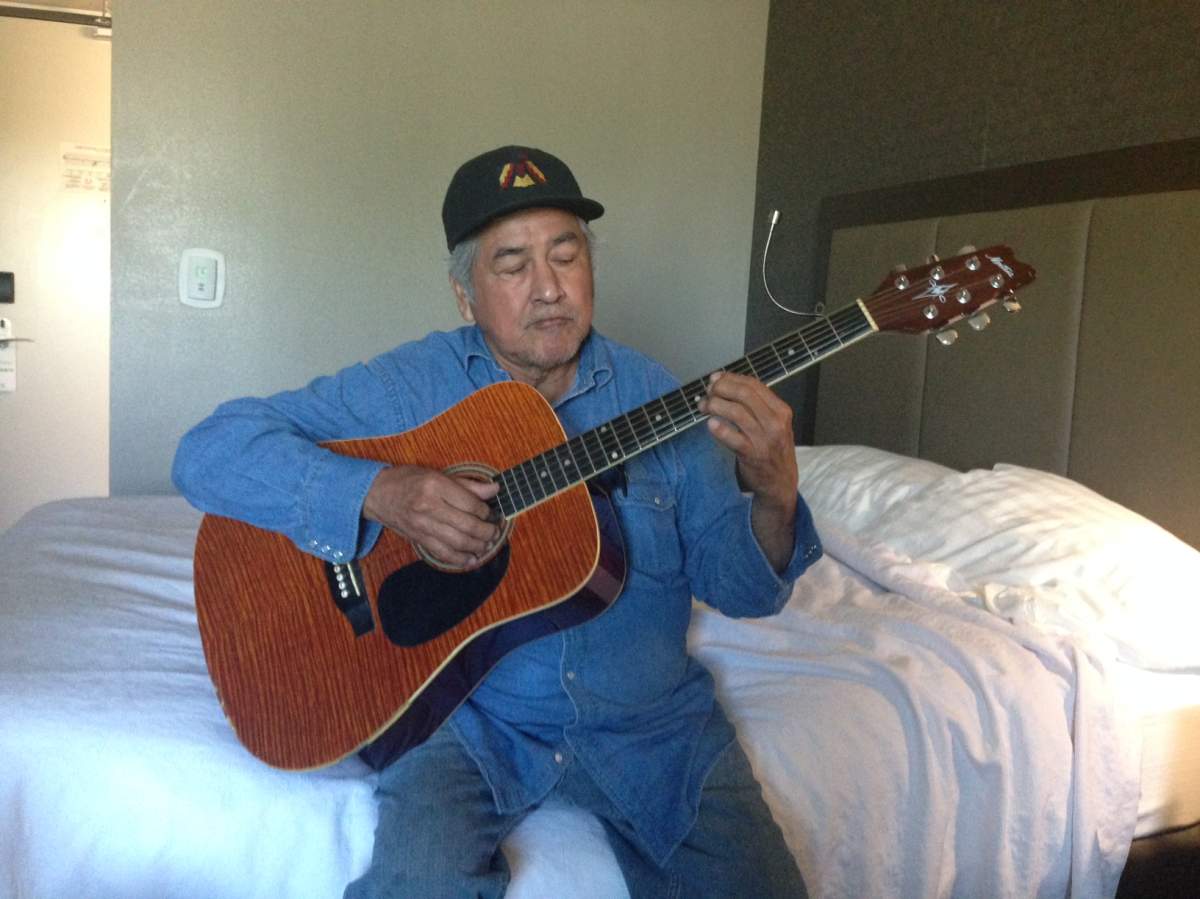 Clemance Assiniboine sits in a hotel room after having to evacuate Long Plain First Nation after a tornado devastated the area.