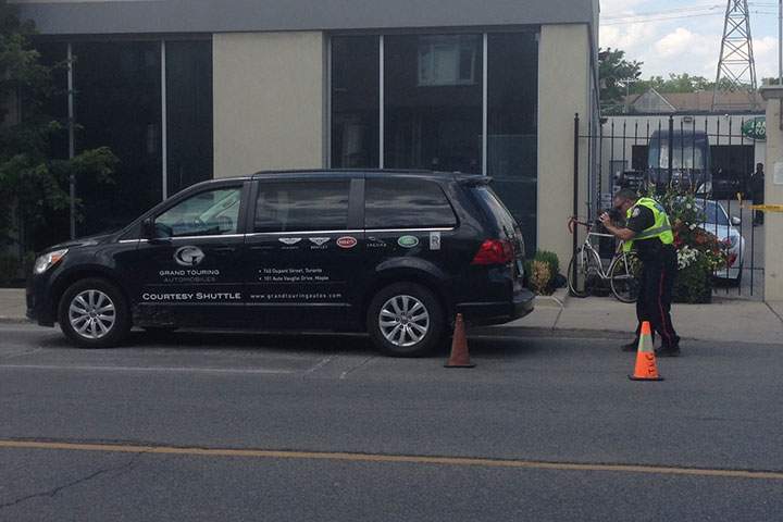 Police investigate after they say a cyclist was fatally injured when he slammed into a parked car while swerving to avoid a turning van.