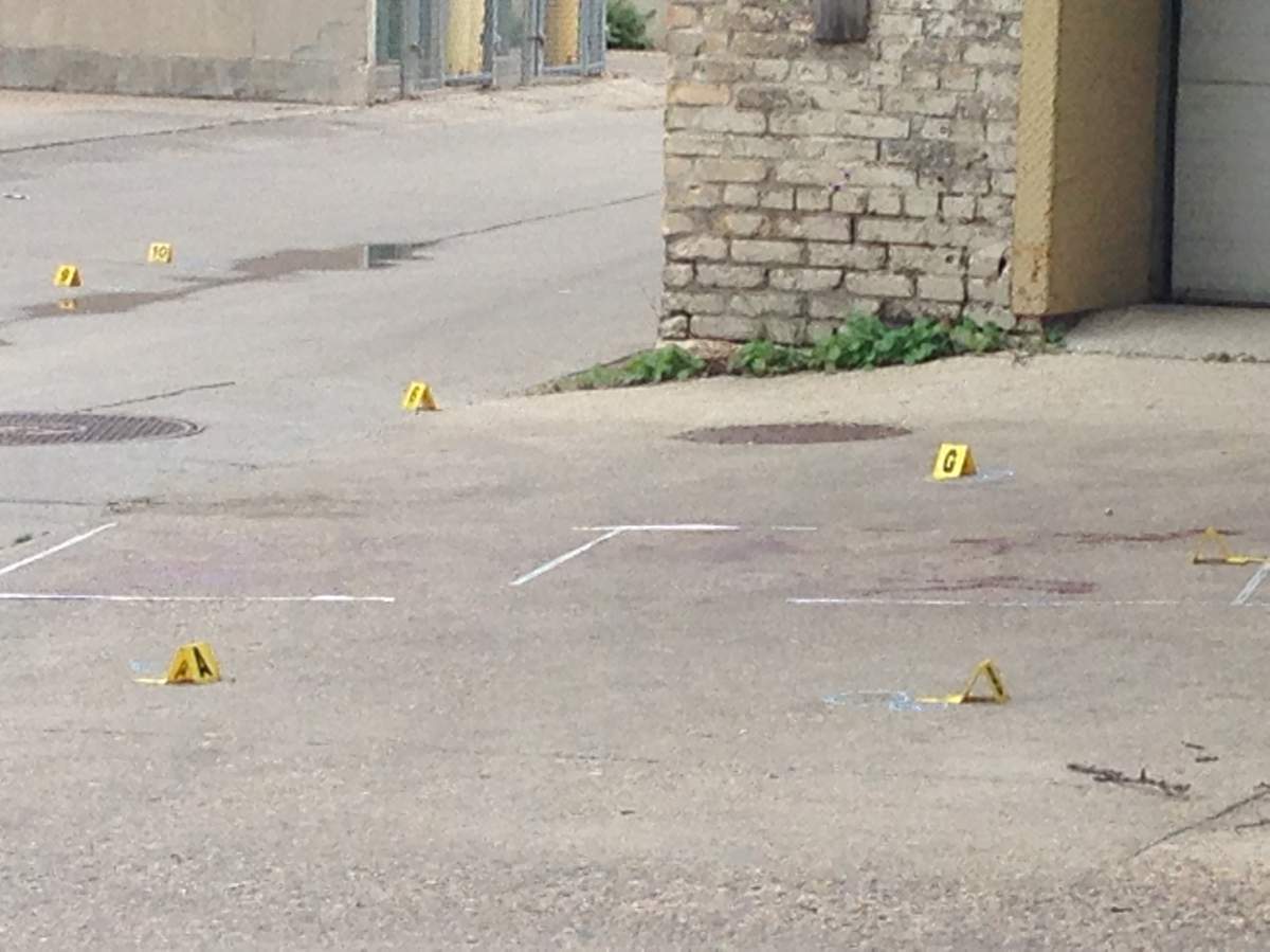 Evidence markers surround a number of blood stains on Donald Street after an early morning homicide.