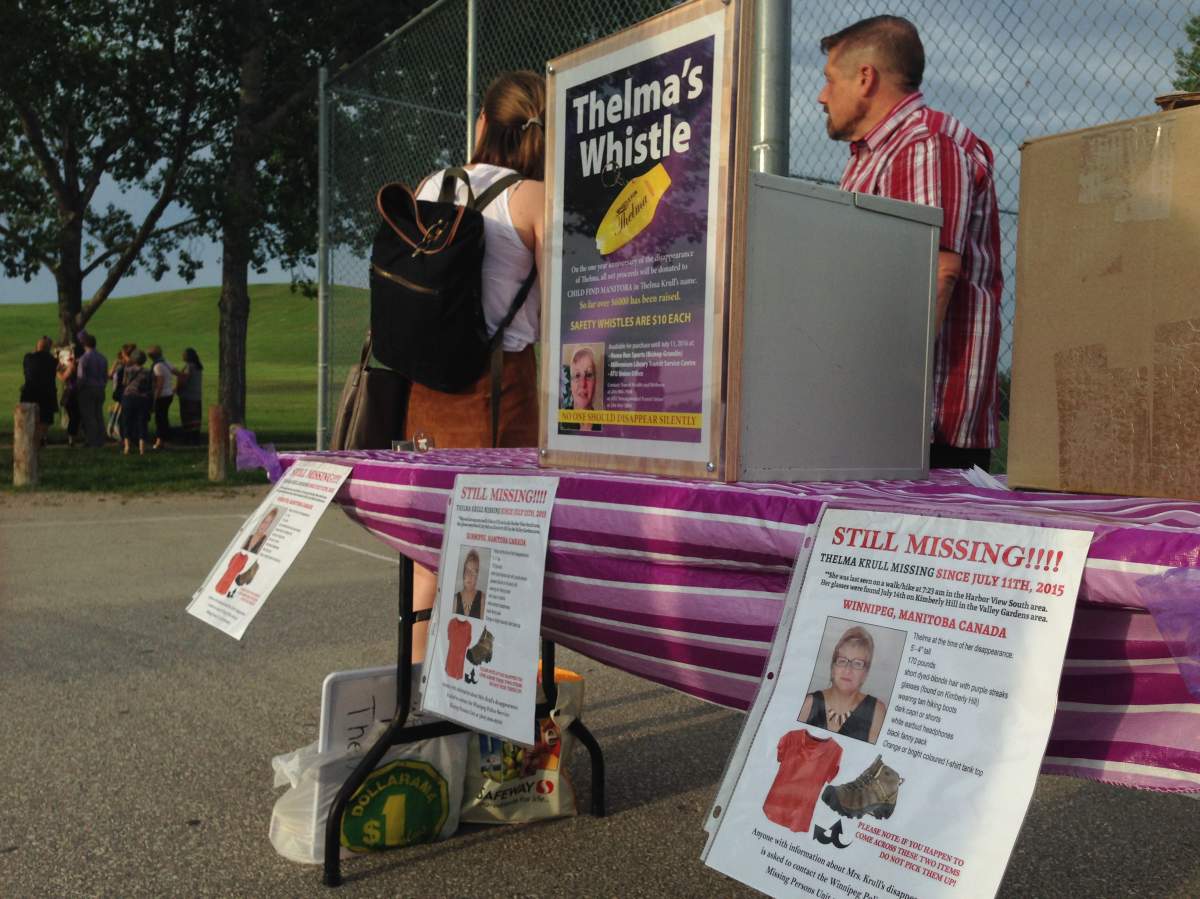 Whistles are sold Monday night at a vigil for Thelma Krull, the 57-year-old grandmother from Winnipeg who has been missing for a year.