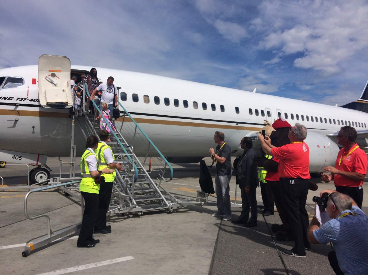 Passengers deplane at YLW.