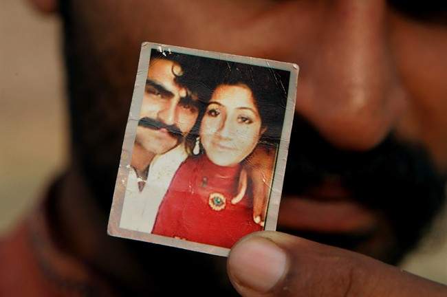 Mohammed Tofeeq shows a picture with his wife Muqadas Tofeeq, who local police say was killed by her mother, in Butrawala village on the outskirts of Gujranwala, Pakistan.