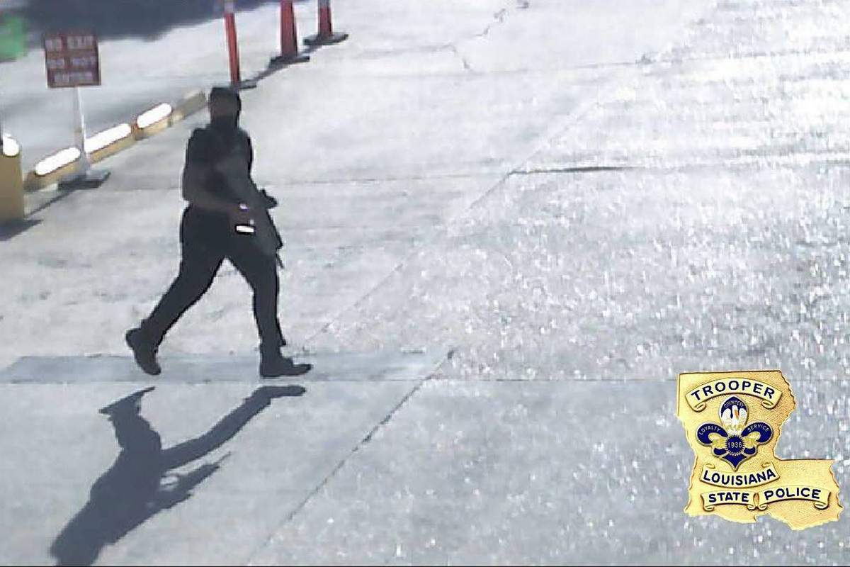 In this Sunday, July 17, 2016, security video frame grab made available by the Louisiana State Police shows Gavin Eugene Long dressed in black and carrying a gun in Baton Rouge, La.