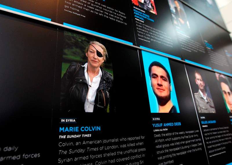 In this May 13, 2013, file photo, the photo of Journalist Marie Colvin who was killed in Syria while she was reporting from there, is seen on the wall of the Newseum during the Journalist Memorial Re-dedication ceremony of the journalists who died reporting the news in 2012 in Washington. 