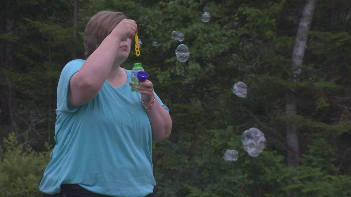 Erin Curwin blew bubbles at daughter Marlie’s grave in Westcock, N.B., on July 9, 2016.