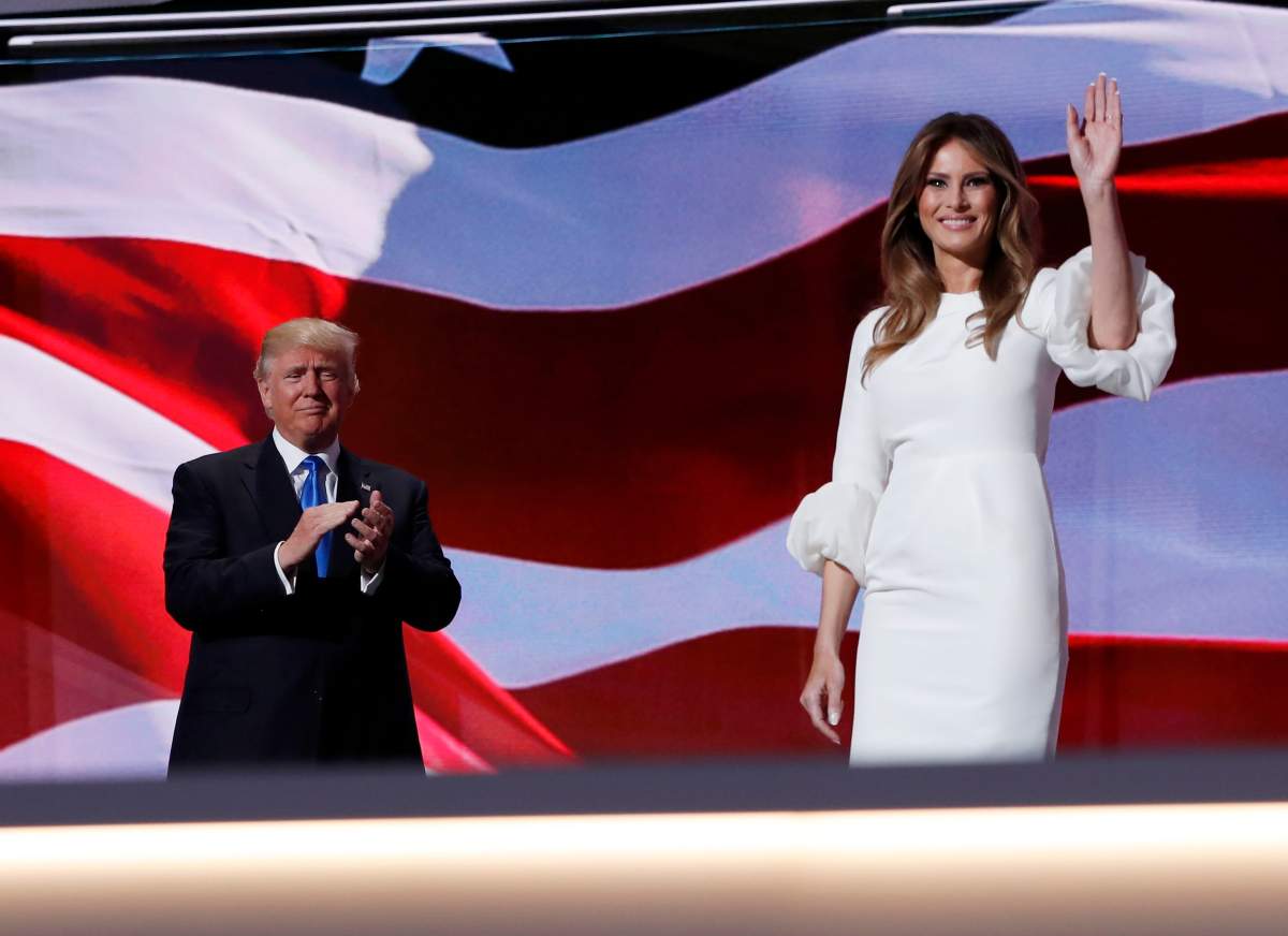 Melania Trump, wife of Republican Presidential Candidate Donald Trump, waves after addressing the delegate as her husband Donald Trump applauds during first day of the Republican National Convention in Cleveland, Monday, July 18, 2016.