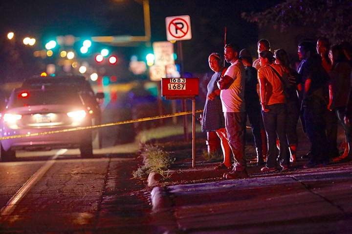 A crowd gathers at the scene of a shooting of a man involving a St. Anthony Police officer on Wednesday, July 6, 2016, in Falcon Heights, Minn.