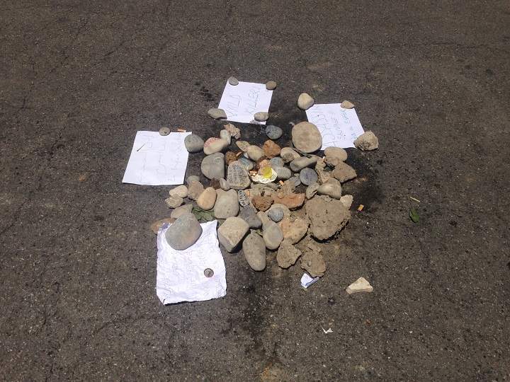 Rocks cover bloodstains on the Promenade des Anglais in Nice, France where police shot the truck driver dead. An angry message reads: ”Savage assassin”and another “Wild Killer.” Sunday, July 17, 2016.