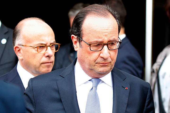 French President Francois Hollande and Interior Minister Bernard Cazeneuve (L) leave the city hall after two assailants had taken five people hostage in the church at Saint-Etienne-du -Rouvray near Rouen in Normandy, France, July 26, 2016.