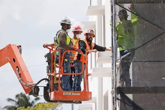 Hard economic times have prompted an organization that bargains for Alberta's unionized building trades to sign a deal that includes lower pay for some workers in the hope of keeping them on the job.