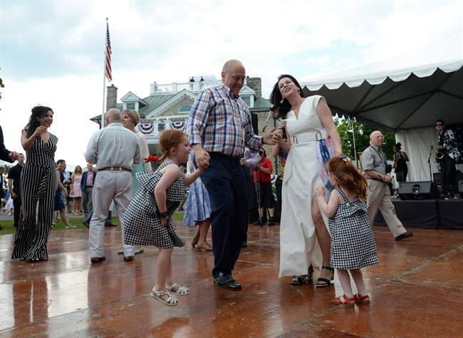 Bruce Heyman and wife Vicki dance with their grandaughters during the 4th of July celebrations in Ottawa on Monday, July 4, 2016.