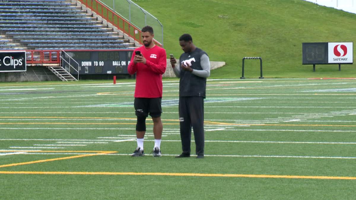 Stampeders wide receivers Juwan Brescasin and DaVaris Daniels playing Pokemon GO at McMahon Stadium post practice Saturday. 