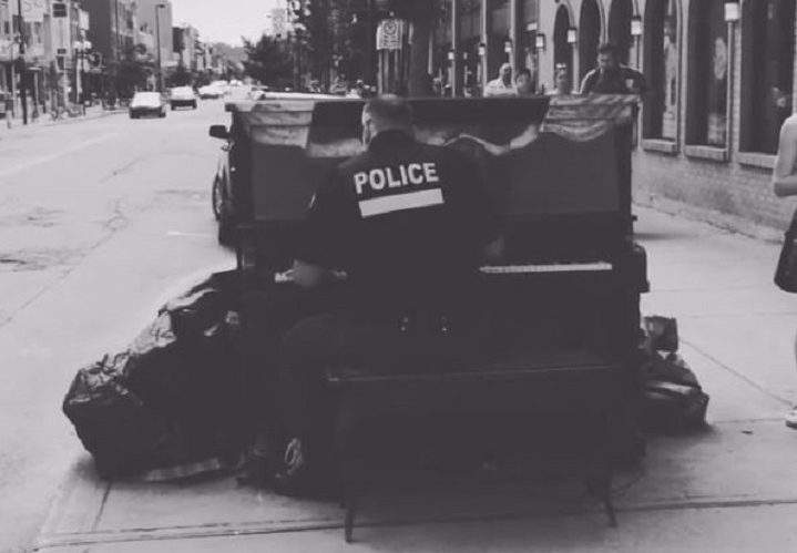Montreal police officer Martin Messier stops to play a tune.