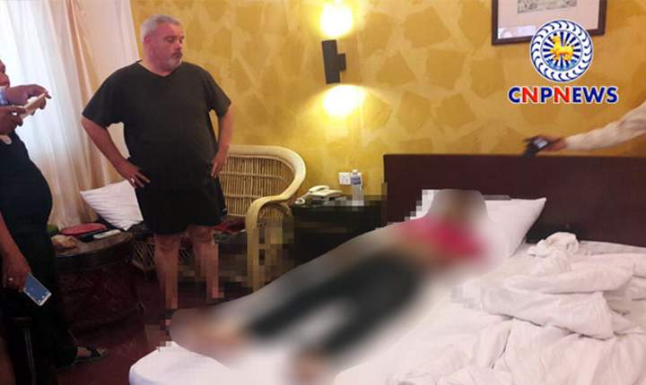 The family of Vinny Bains says this photo (which has been edited for graphic content) shows Tony Cecchini with police in the room where Vinny Bains was found dead in Phnom Penh, Cambodia on June 25, 2016.