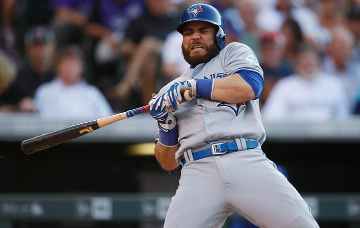 Toronto Blue Jays' Russell Martin reacts as he gets hit by a pitch from Colorado Rockies starting pitcher Jon Gray in the second inning of a baseball game Monday, June 27, 2016, in Denver. 