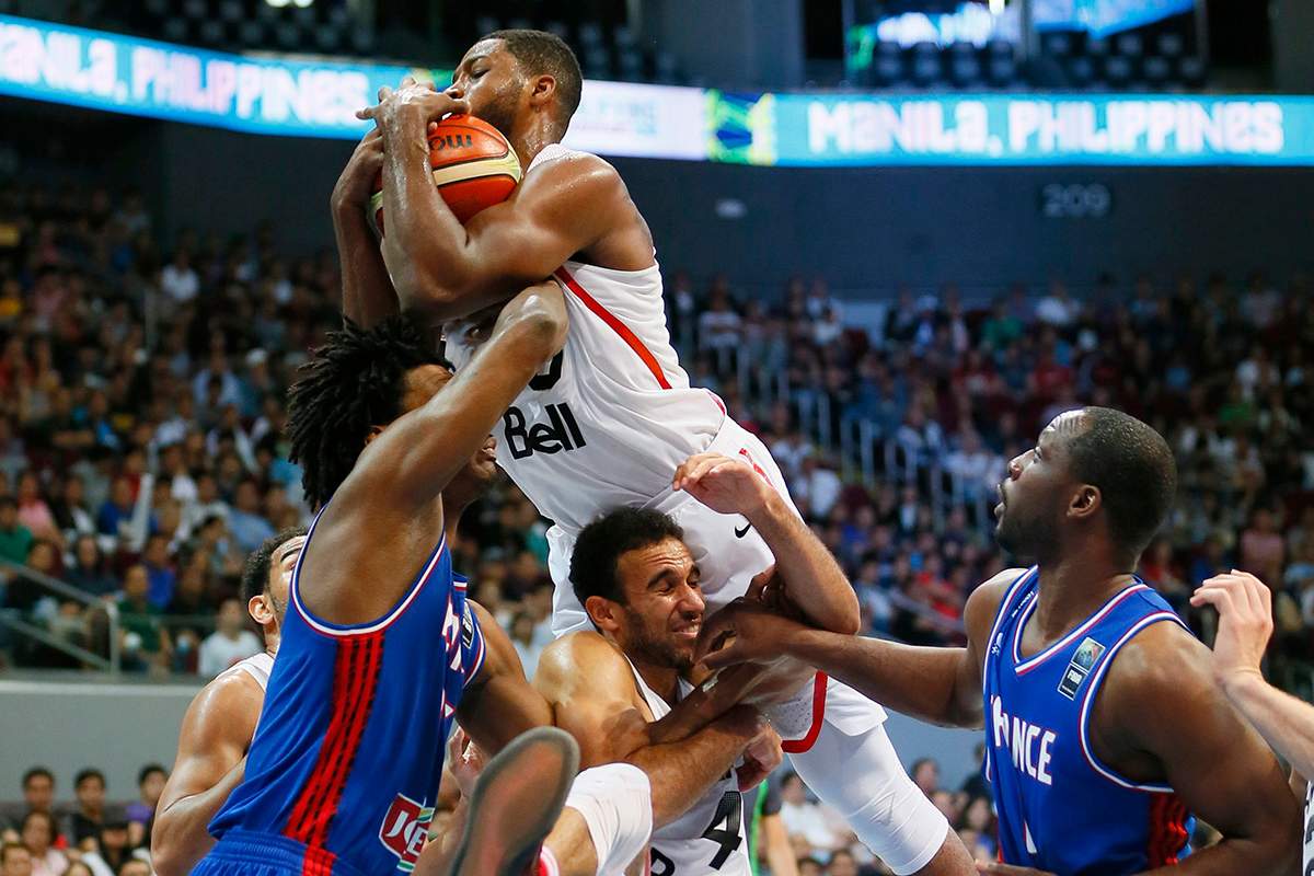 Canada's Tristan Thompson leaps high for a rebound during their finals basketball match in the FIBA Olympic Qualifying basketball match against France Sunday, July 10, 2016 at the Mall of Asia Arena in suburban Pasay city south of Manila, Philippines.
