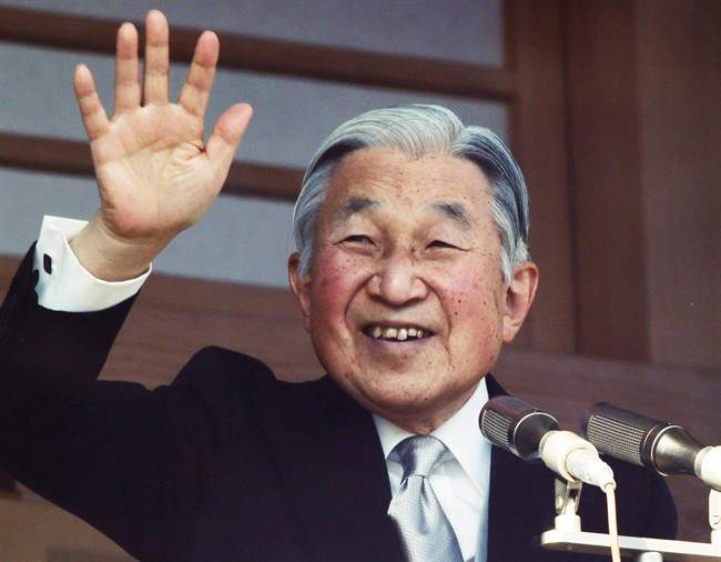 In this Jan. 2, 2016, file photo, Japan's Emperor Akihito waves to well-wishers from a bullet-proofed balcony of the Imperial Palace during New Year's public appearance in Tokyo.
