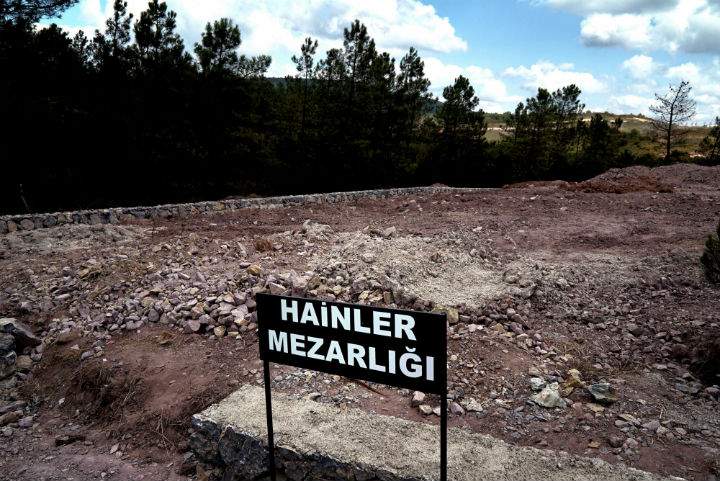A sign reading in Turkish "Traitors' Cemetery" is seen in front of unmarked graves, built specifically to hold the bodies of coup plotters who died in the failed military coup of July 15, in eastern Istanbul Wednesday, July 27, 2016.