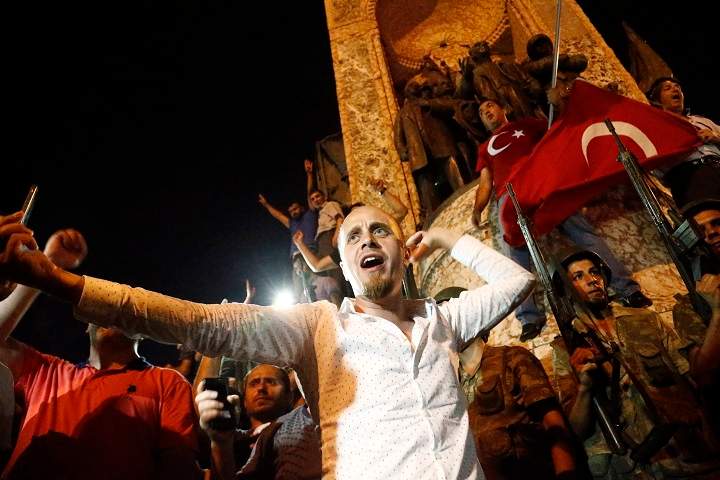 Supporters of President of Turkey Recep Tayyip Erdogan shout slogans at the Taksim Square in Istanbul, Turkey, 16 July 2016. Turkish Prime Minister Yildirim reportedly said that the Turkish military was involved in an attempted coup d’etat. The Turkish military meanwhile stated it had taken over control.
