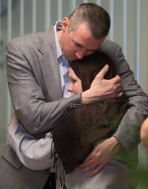 John Nuttall, back, and Amanda Korody embrace at B.C. Supreme Court after a judge ruled the couple were entrapped by the RCMP in a police-manufactured crime, in Vancouver on Friday, July 29, 2016. Justice Catherine Bruce said police instigated and skillfully engineered the very terrorist acts committed by John Nuttall and Amanda Korody, who believed they were planting pressure-cooker bombs that would blow up at the legislature on Canada Day in 2013. 