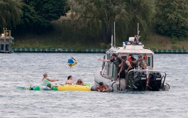 A Customs and Border Protection boat helps floaters during Float Down on the St. Clair River in Port Huron, Mich., Sunday, Aug. 21, 2016. 