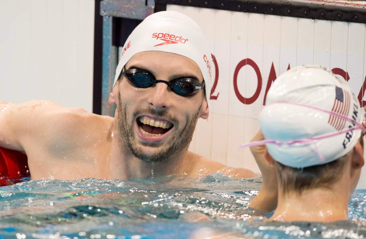 Canadian swimmer Ryan Cochrane laughs as he chats with USA swimmer Missy Franklin in the pool while training at the 2016 Summer Olympics Thursday, August 4, 2016 in Rio de Janeiro, Brazil.