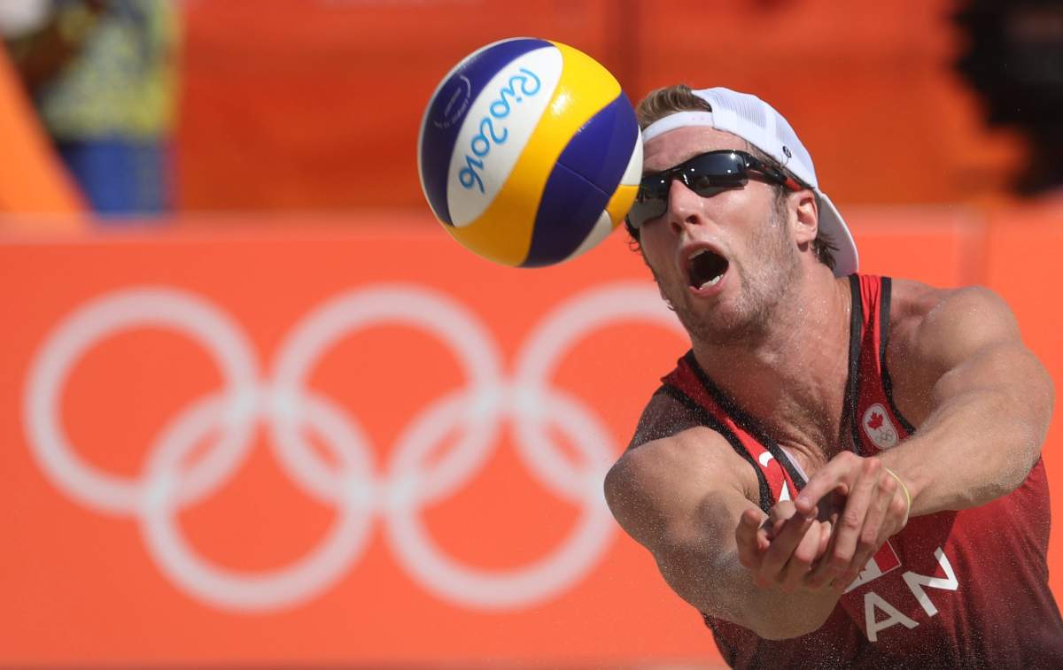 Canada’s Sam Schachter sets a ball during a men’s beach volleyball match against Brazil at the 2016 Summer Olympics in Rio de Janeiro, Brazil, Saturday, Aug. 6, 2016.