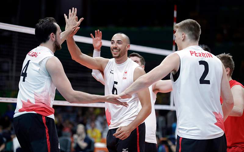 Members of team Canada celebrate during a men's preliminary volleyball match against the United States at the 2016 Summer Olympics in Rio de Janeiro, Brazil, Sunday, Aug. 7, 2016. 