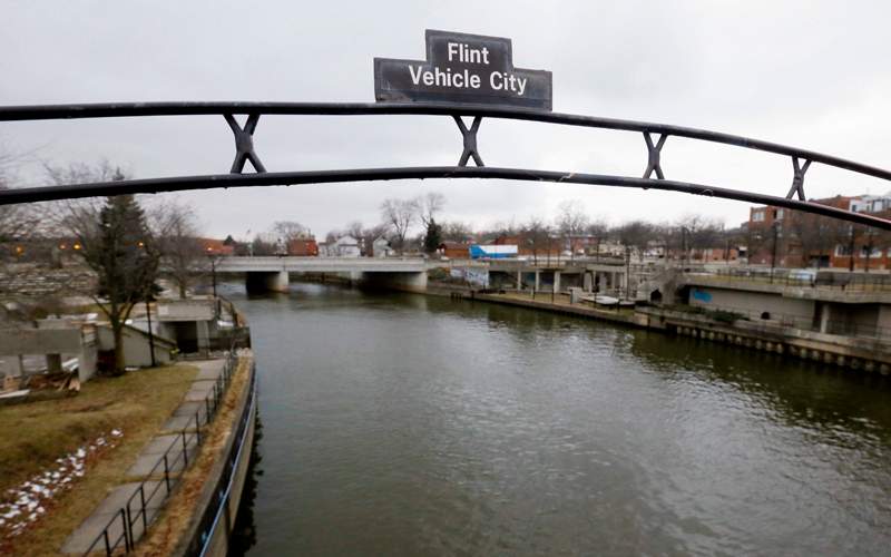 A sign over the Flint River in Flint, Mich. 