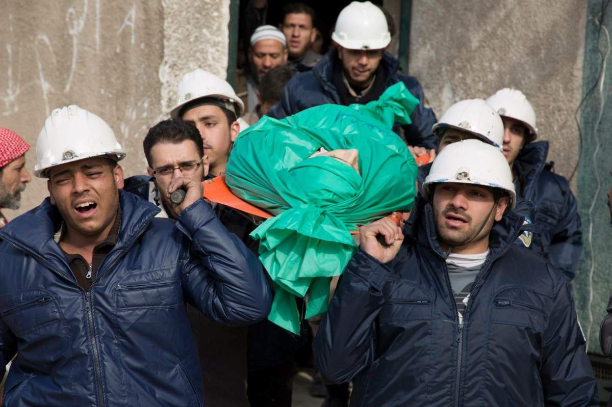 In this Wednesday, Sept. 16, 2015 file photo, comrades carry Ilias Mahmoud al-Taweel, a member of Syrian Civil Defence, or White Helmets, during his funeral in in Douma, the suburbs of Damascus.