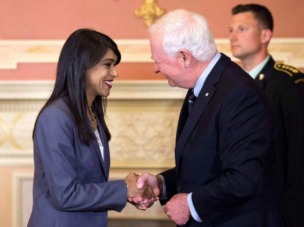 Minister of Small Business and Tourism Bardish Chagger shakes hands with Governor General David Johnston after being sworn in as Leader of the Government in the House of Commons at Rideau Hall on Friday, Aug. 19, 2016 in Ottawa.