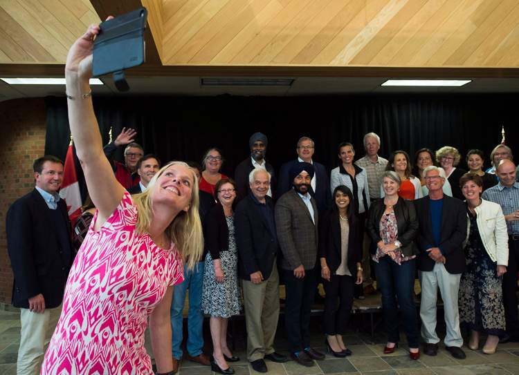 Environment Minister Catherine McKenna, left, takes a selfie at a Liberal cabinet retreat in 2016. Justin Trudeau's cabinet has an equal number of men and women.