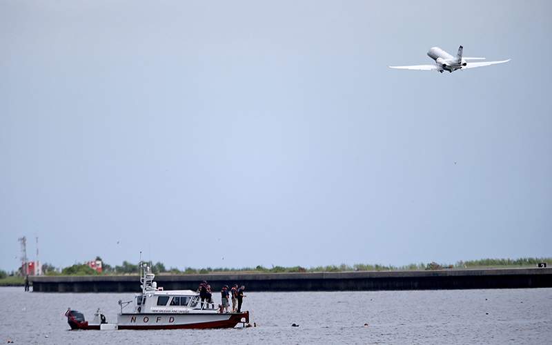 A New Orleans Fire Department boat carrying divers searches for wreckage Sunday, Aug. 28, 2016, near the Seabrook Bridge after a plane crashed into Lake Pontchartrain Saturday night near Lakefront Airport in New Orleans. 