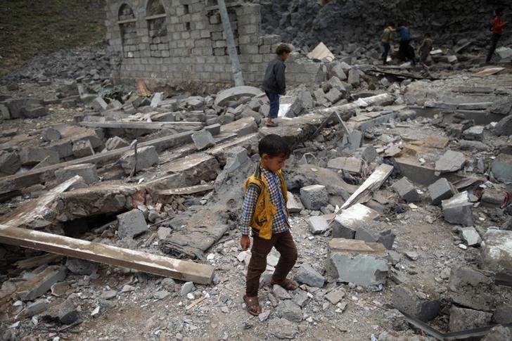 A boy walks on rubble of a house after it was destroyed by a Saudi-led air strike in Yemen's capital Sanaa, August 11, 2016. 