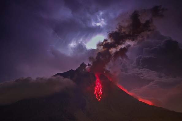 A general view of spewing pyroclastic lava is seen during Mount Sinabung volcano eruption, seen from Tiga Pancur village in Karo, North Sumatra, Indonesia on July 28, 2016. (Photo by Tibta Pangin/Anadolu Agency/Getty Images).