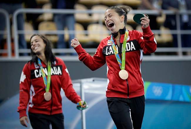Canada's bronze medalists Roseline Filion, right, and Meaghan Benfeito celebrate after the women's synchronized 10m platform diving final in the Maria Lenk Aquatic Center at the 2016 Summer Olympics in Rio de Janeiro, Brazil, Tuesday, Aug. 9, 2016.