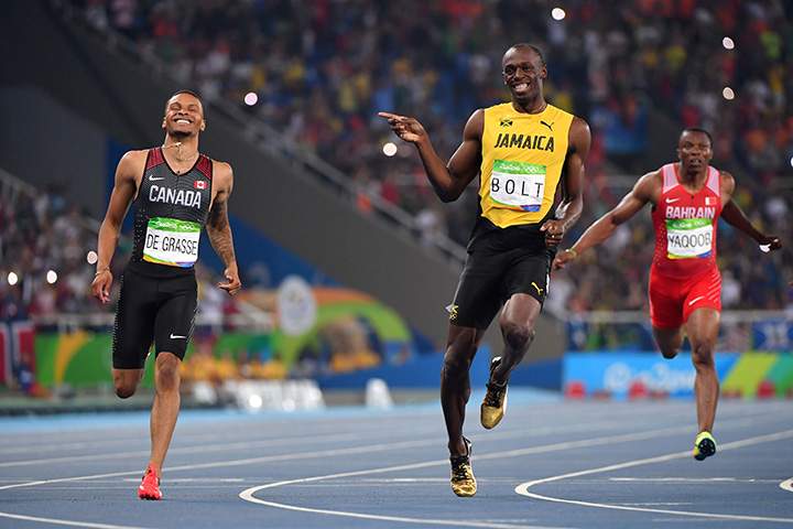 Jamaica’s Usain Bolt jokes with Canada’s Andre De Grasse after they crossed the finish line in the men’s 200m semi-final during the athletics event at the Rio 2016 Olympic Games on August 17, 2016.