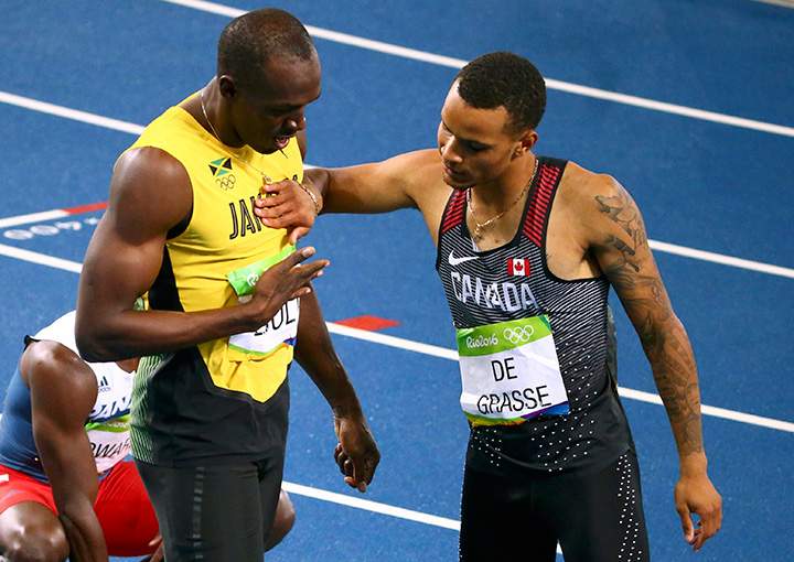 Jamaica’s Usain Bolt and Canada’s Andre De Grasse celebrate after the men’s 200-metre final at the Rio Olympics on August 18, 2016. 